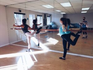 Senior contemporary modern ballet students enjoying leg work & arabesque training
