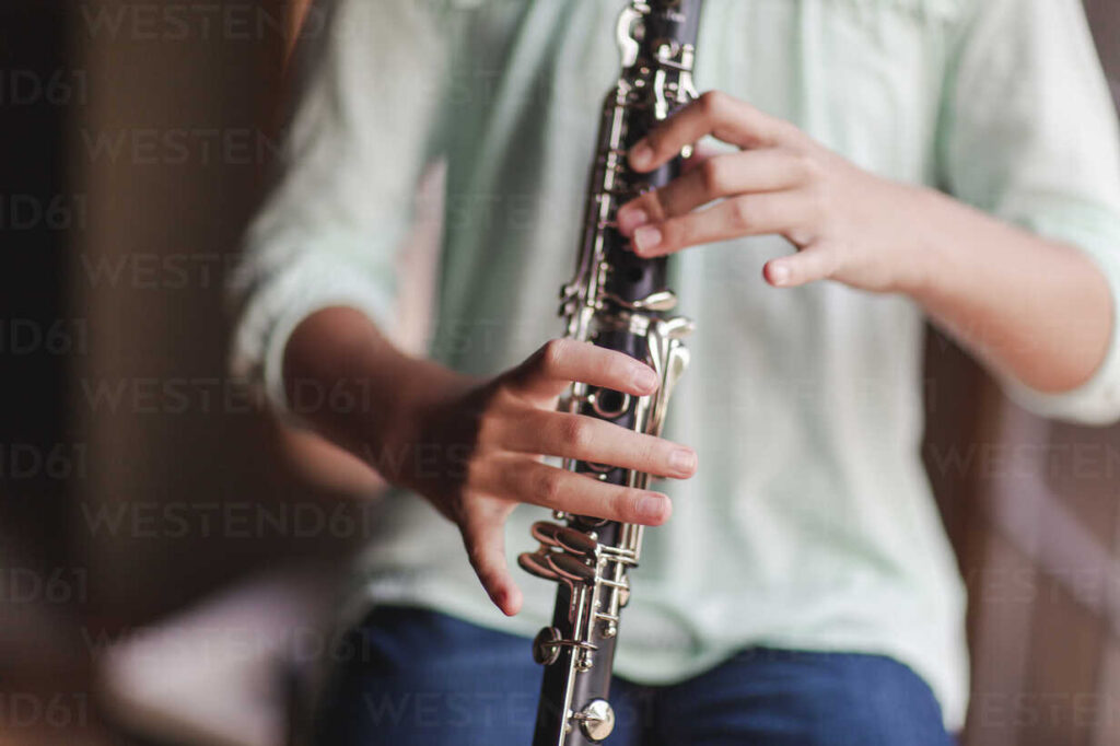 student playing clarinet in music lesson