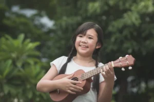 young girl playing ukulele music lessons