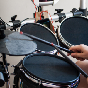 Student playing drums in music lesson