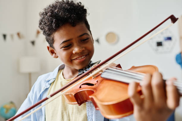student playing violin in music lesson